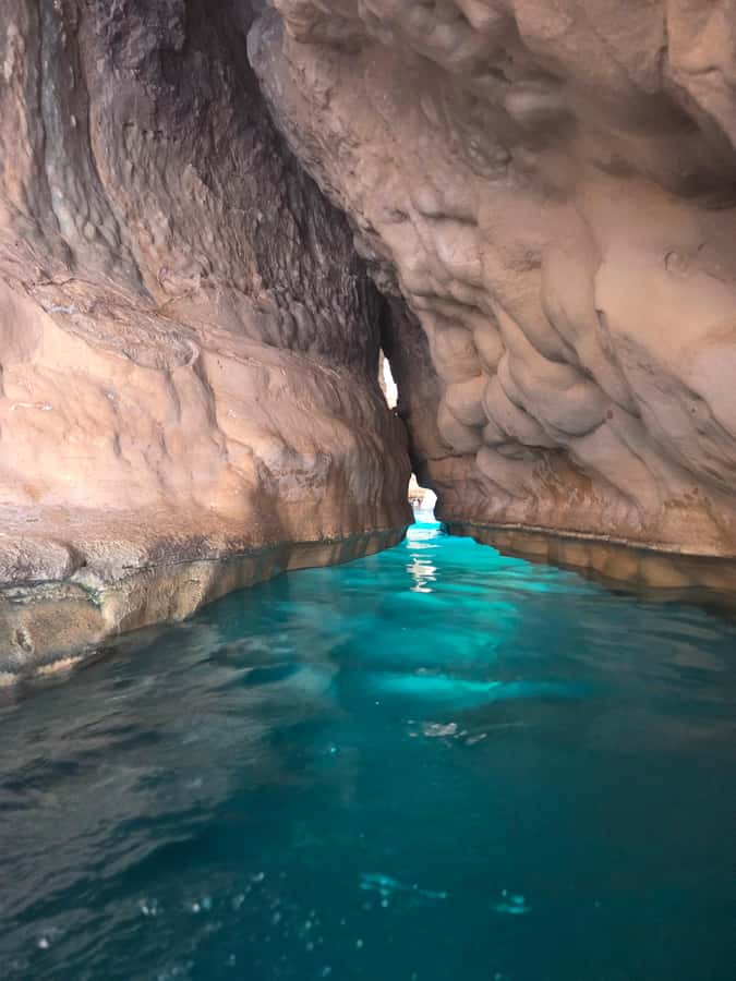 From Muscat: Wadi Shab Expedition - Swimming toward the cave waterfall