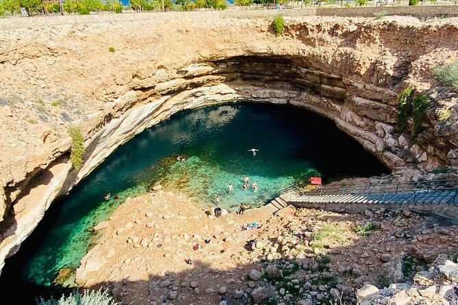 Full Day Group Tour to Wadi Shab Bimmah Sinkhole and Fins Beach - Bimmah Sinkhole: Strange, Pretty, and Brief