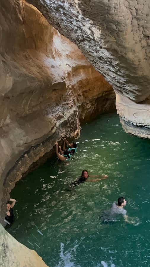 Muscat: Wadi Shab, Romantic Cave and Sinkhole Full-day Trip - Crossing the river by boat