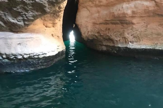 Private Day Trip to Wadi Shab & Bimmah Sinkhole Price Up To 5 Persons - Looking into the blue water at Bimmah Sinkhole